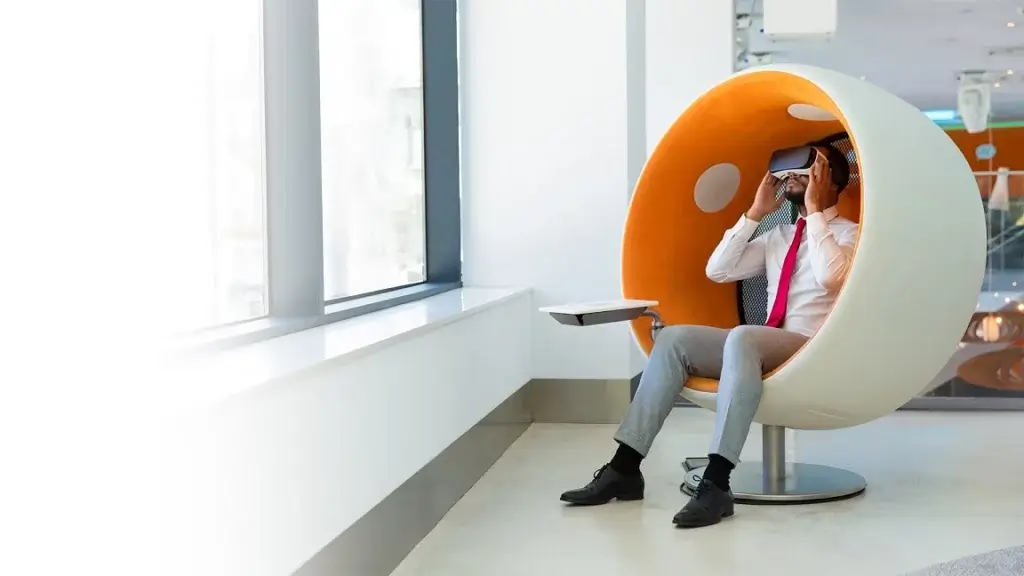 AR and VR Transforming Businesses Man office employee sitting on round chair using vr headset 